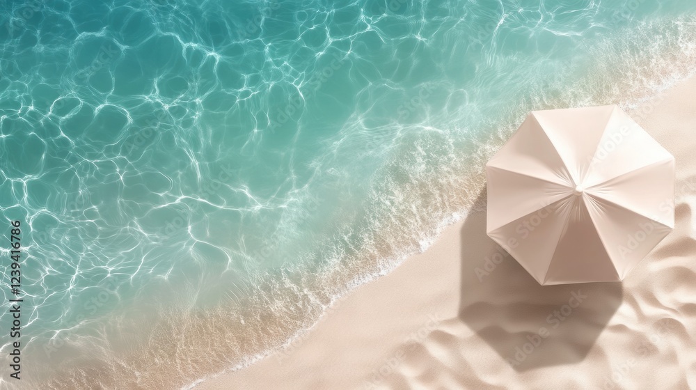 Fototapeta premium Summer background with a beach parasol near the sea waves. top view, free copy space