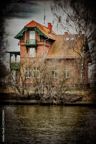 Ghosty abandoned house on the riverbank
 photo