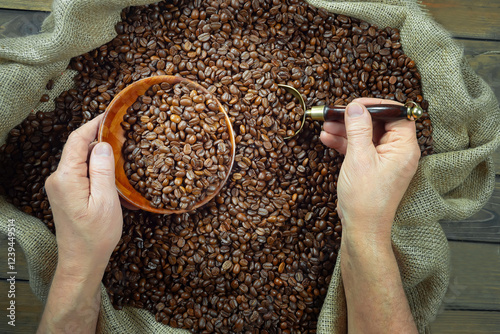 Coffee beans in the hands of an elderly man. Close-up.