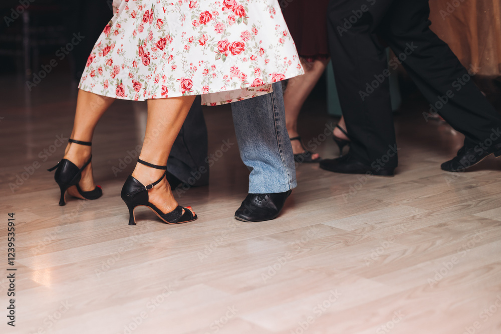 Dancing stiletto shoes of couples dancing traditional latin argentinian dance milonga in the ballroom, tango salsa bachata kizomba lesson in red and purple lights, evening dance school class festival Dancing stiletto shoes of couples dancing traditional latin argentinian dance milonga in the ballroom, tango salsa bachata kizomba lesson in red and purple lights, evening dance school class festival