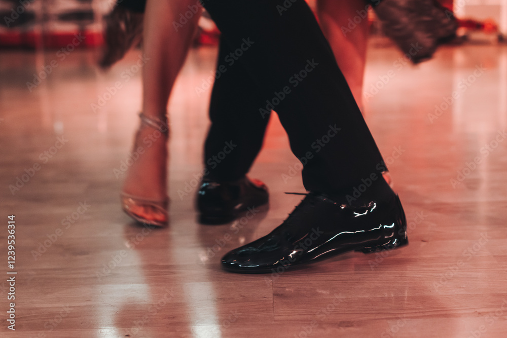 Dancing stiletto shoes of couples dancing traditional latin argentinian dance milonga in the ballroom, tango salsa bachata kizomba lesson in red and purple lights, evening dance school class festival Dancing stiletto shoes of couples dancing traditional latin argentinian dance milonga in the ballroom, tango salsa bachata kizomba lesson in red and purple lights, evening dance school class festival
