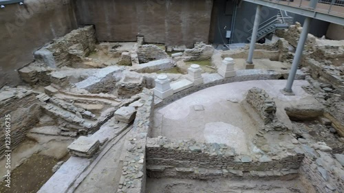 Thessaloniki, Greece Agias Sofias metro station exterior public ticket-free area where visitors can observe ancient ruins from a pedestrian walkway.