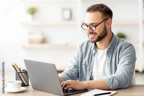 Millennial male tutor with laptop teaching Turkish online from home. Confident young man conducting educational web conference, working for abroad country, emigrating to Turkey photo