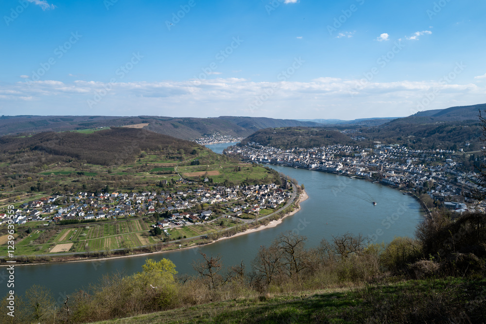 Serene river scene: A charming town nestled in a lush green valley, viewed from an elevated perspective. Serene river scene: A charming town nestled in a lush green valley, viewed from an elevated perspective.