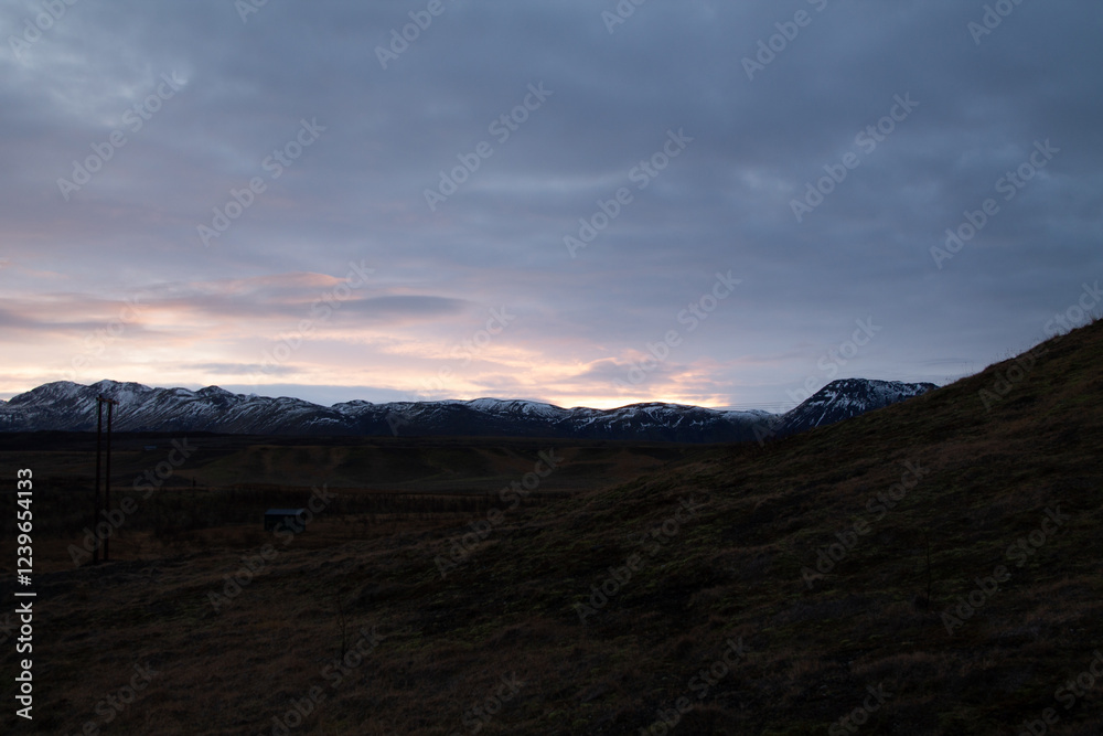 Sunrise over a field with mountains in the background Sunrise over a field with mountains in the background