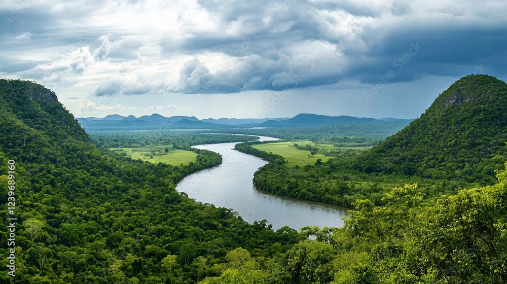 Obraz premium Serene River Landscape Surrounded by Green Hills and Dramatic Sky