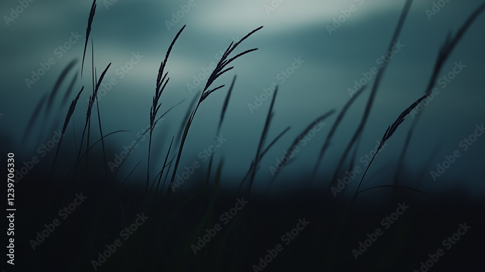 Obraz premium Serene Silhouette of Tall Grass Against a Moody Blue Sky at Dusk : Generative AI