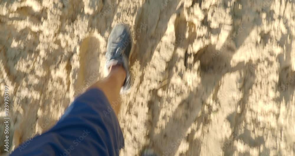 POV of man legs in sneakers walking along dirty mud road after rain. POV of man legs in sneakers walking along dirty mud road after rain.