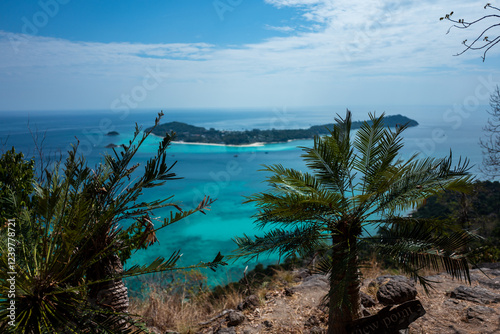 Behold this breathtaking tropical island vista: turquoise waters, lush greenery, and a panoramic view from above! photo