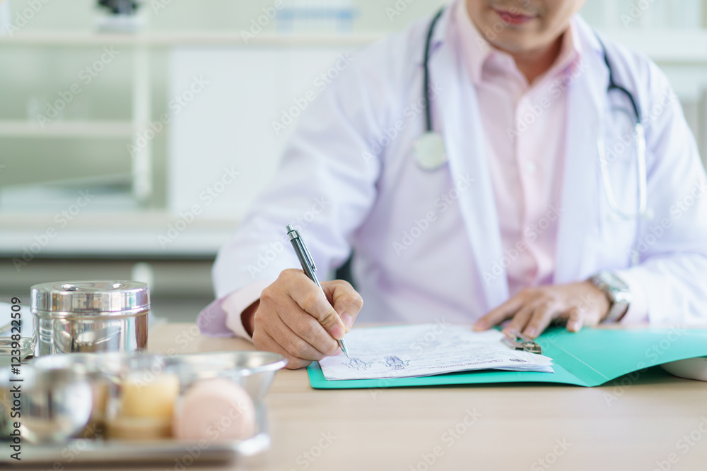 Asian doctor is working on a documents and papers report in the office in hospital. Asian doctor is working on a documents and papers report in the office in hospital.