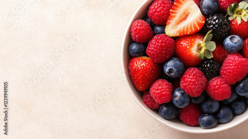 bowl of colorful mixed berries including strawberries, blueberries, and raspberries