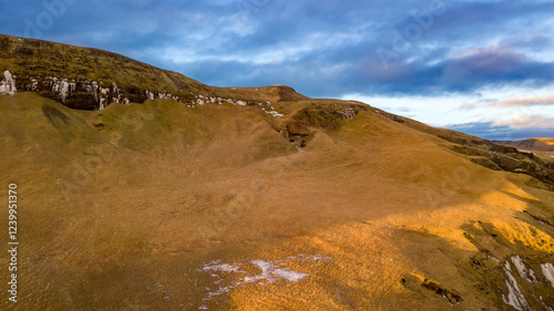 Aerial landscape view of hill range beside Fjaðrárgljúfur or Fjadrargljufur Canyon in Iceland. Taken by drone. Nature, travel, winter background, or wallpaper photo