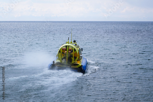 Canvas Print A hovercraft floats on the unfrozen Lake Baikal