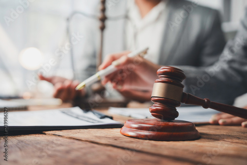 Lawyers discussing contract behind judge gavel in courtroom