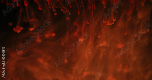 Blur fluid smoke. Liquid ink paint. Defocused red orange color shine drops flow vapor cloud texture waves on abstract art dark black background.