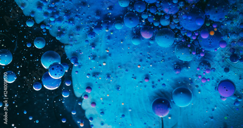 Art flow. Bubble ink. Mystical pouring blue emulsion floating gel acrylic purple drops. Wave mix particles colorful abstract background.