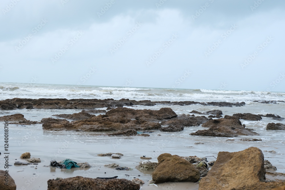 Majestic Rocky Beach with Crashing Waves and Overcast Sky in Natural Coastal Scenery Majestic Rocky Beach with Crashing Waves and Overcast Sky in Natural Coastal Scenery