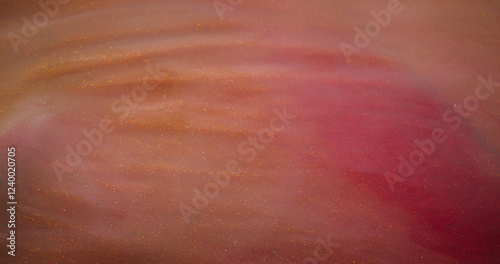 Paint flow. Shimmering fluid. Pink peach changing color stream mystic sparkling ambiance twisting marble defocused abstract background.