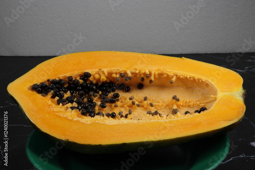 Fresh and organic ripe papaya whole vegetable on the plate. Famous tropical fruit in Asia.