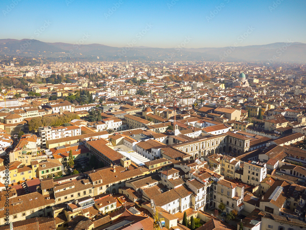 Fototapeta premium Aerial panoramic view of Florence, Italy, the historic city center with terracotta rooftops and Renaissance architecture from Brunelleschi Dome. Dense urban layout of Tuscan capital 