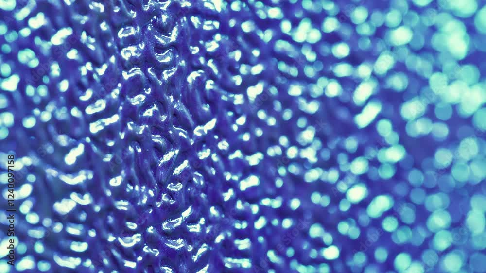 Blurred texture. Plastic sheet. Colored patterned artificial leather relief with changing lighting. Decorative bright flare purple blue skin background. Blurred texture. Plastic sheet. Colored patterned artificial leather relief with changing lighting. Decorative bright flare purple blue skin background.