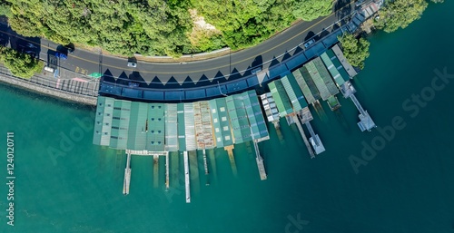 Aerial view of a marina with numerous docks and boat houses. Green roofs and walkways. Tranquil water. BOAT SHEDS, ORAKEI, AUCKLAND, NEW ZEALAND