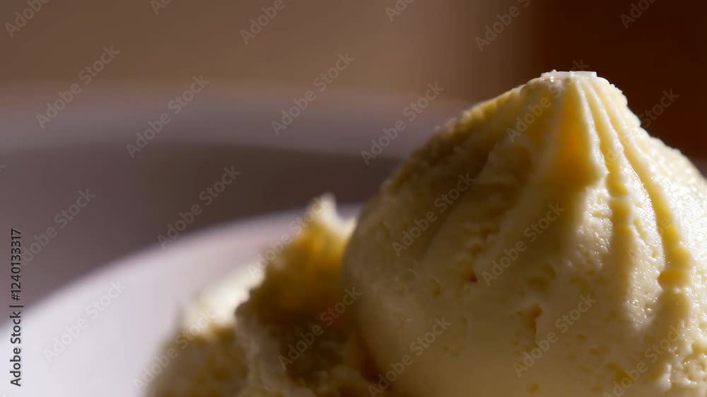 A white plate topped with a scoop of ice cream A white plate topped with a scoop of ice cream