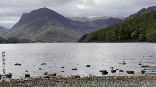 Lakeside view from the shores of Lake Buttermere with Fleetwith Pike and forest in the background - Buttermere, Lake District photo