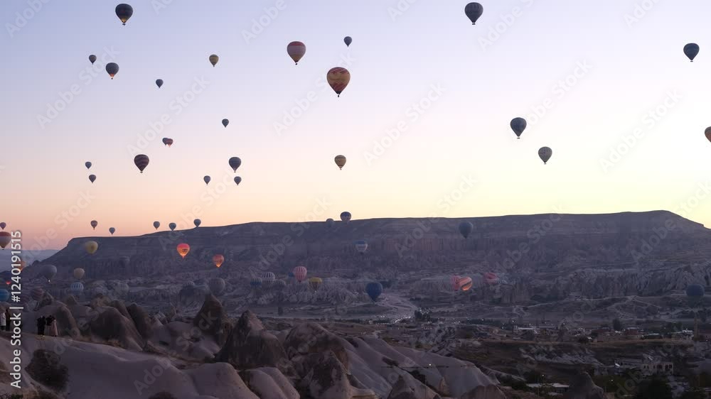 Hot air balloons ride over Goreme open air museum and Cappadocia fairy chimneys at sunrise. Turkey's UNESCO tourism landmarks. Nevsehir, Turkey country - 4k video Hot air balloons ride over Goreme open air museum and Cappadocia fairy chimneys at sunrise. Turkey's UNESCO tourism landmarks. Nevsehir, Turkey country - 4k video