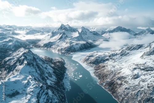 Wallpaper Mural Aerial view of snow-covered mountains and a serene river flowing through a scenic landscape, showcasing the beauty of nature's untouched wilderness. Torontodigital.ca