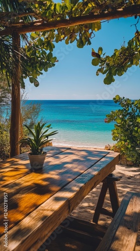 Relaxing wooden table with a view of the turquoise ocean under a clear blue sky