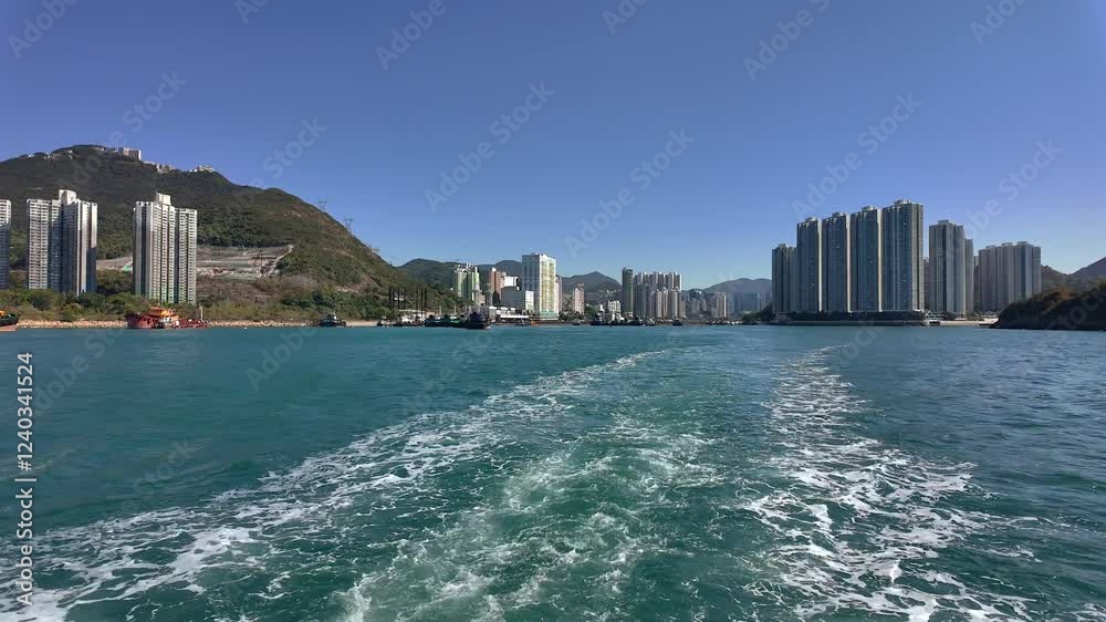 Hong Kong - January 12, 2025: View from a boat sailing from Hong Kong Island Hong Kong - January 12, 2025: View from a boat sailing from Hong Kong Island