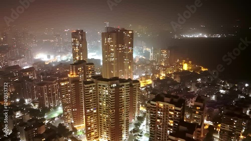 Drone shot dazzling cityscape with lit up urban towers