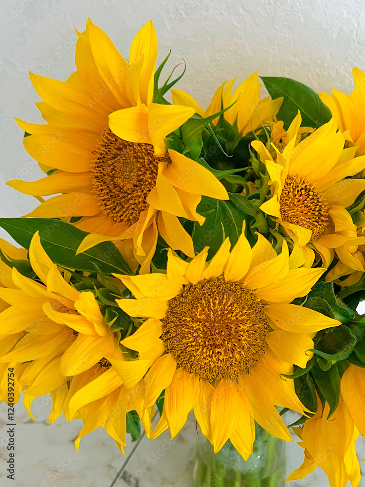 A bouquet of sunflowers is close. Vertical photography. Yellow color
