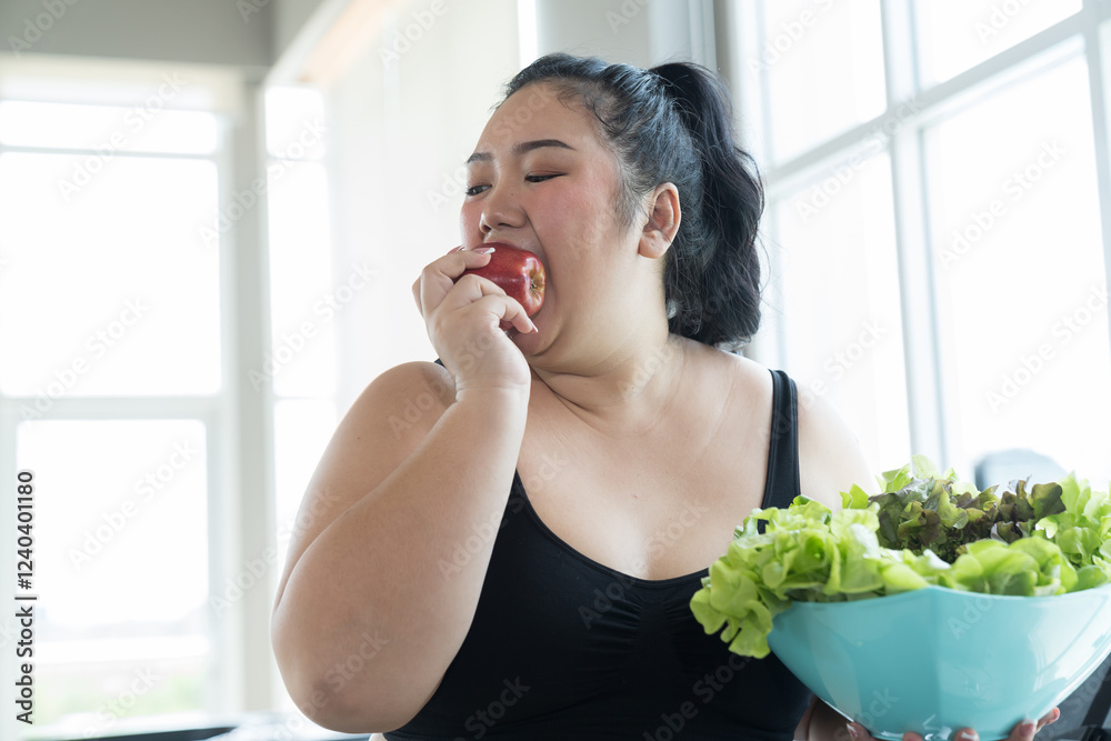 Asian young plus size woman eating fruits and vegetables during workout in fitness sport club. Young oversize woman eating fruits and vegetables during exercise in gym. Oversize woman eating in gym Asian young plus size woman eating fruits and vegetables during workout in fitness sport club. Young oversize woman eating fruits and vegetables during exercise in gym. Oversize woman eating in gym