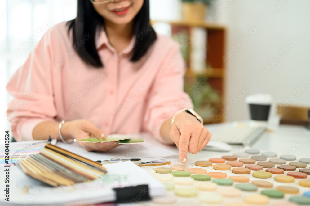 Creative interior designer working on a new project analyzing color palettes and material samples Creative interior designer working on a new project analyzing color palettes and material samples