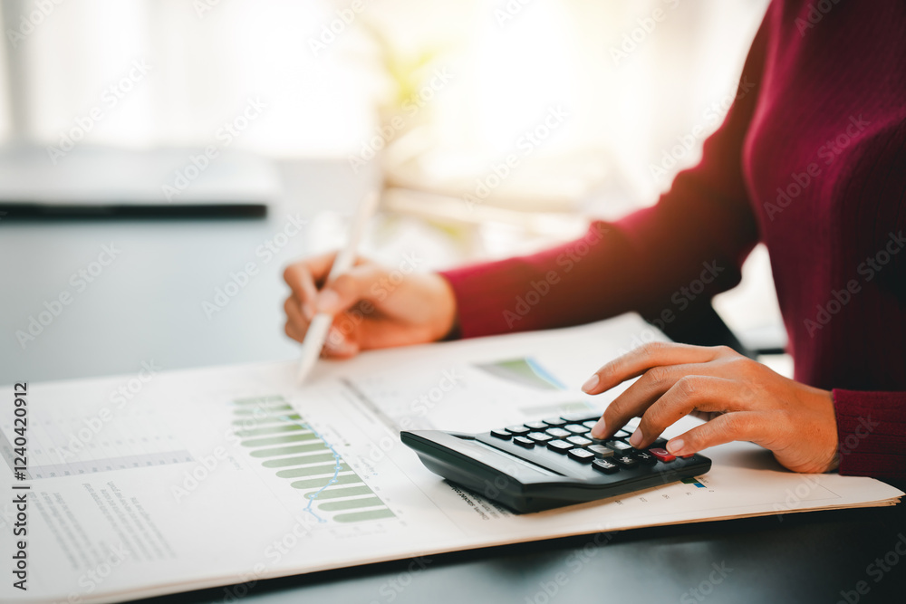 Accountant working on desk using calculator to calculate financial report in office business accounting finance concept Accountant working on desk using calculator to calculate financial report in office business accounting finance concept