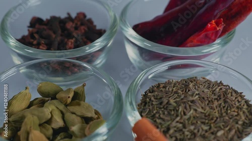 different types of indian whole spices or garam masala in small glass bowl, 4k, push in shot. photo