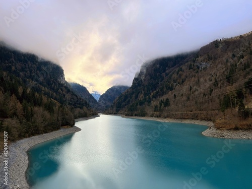 Magic photo of a lake reflecting the mountains during a hike in the Swiss Alps photo