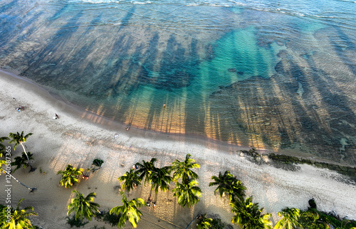 Aerial view of beautiful Praia do Forte beach with turquoise clear water and palm trees, Mata de Sao Joao, Brazil. photo