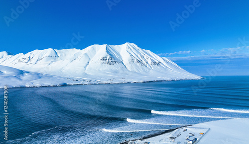 Aerial view of the majestic Troll Peninsula with snow-covered mountains and a frozen sea, Olafsfjordur, Iceland. photo