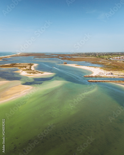 Aerial view of the beautiful coastline with tranquil waters and sandy beaches, Peninsula de Cacela, Praia de Cacela Velha, Portugal. photo