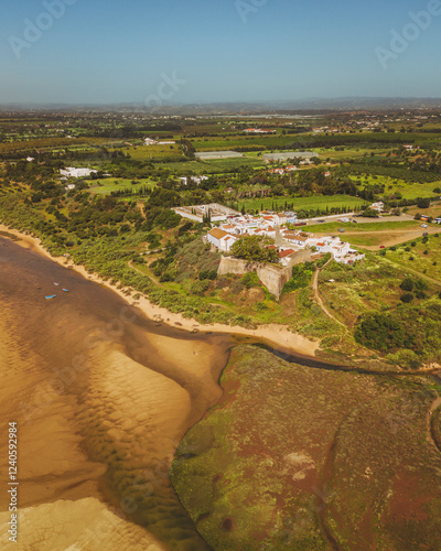 Aerial view of scenic Praia de Cacela Velha with beautiful coastline and tranquil fields, Vila Nova de Cacela, Portugal. photo