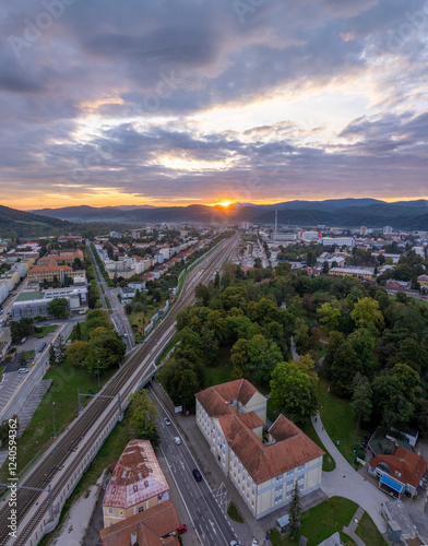 Aerial view of Trencin cityscape at sunrise with Vah river and surrounding mountains, Trencin, Slovakia. photo