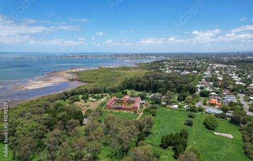 Aerial view of tranquil Moreton Bay with Cleveland Point and historic Ormiston House in a lush residential area, Ormiston, Queensland, Australia.