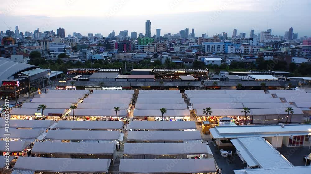 BANGKOK, THAILAND - AUGUST 2024 : View of “The One Ratchada night market” in sunset. High angle 4K time lapse shot, dusk to night. BANGKOK, THAILAND - AUGUST 2024 : View of “The One Ratchada night market” in sunset. High angle 4K time lapse shot, dusk to night.