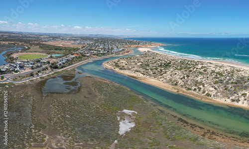 Aerial view of the beautiful Onkaparinga River Ngangkiparri winding through the rugged coastline and serene beach, Port Noarlunga South, Australia. photo