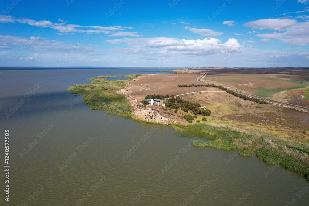 Aerial view of Point Malcom Lighthouse and the tranquil waters of Lake Alexandrina with a scenic coastline, Meningie, Australia. Aerial view of Point Malcom Lighthouse and the tranquil waters of Lake Alexandrina with a scenic coastline, Meningie, Australia.