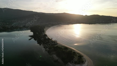 Aerial view of Playa Ladeira with serene sunset glow over Ramallosa Lagoon, Baiona, Spain. photo