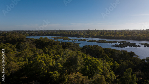 Aerial view of tranquil Lake Goollelal surrounded by serene woodland and lush greenery, Kingsley, Australia. photo